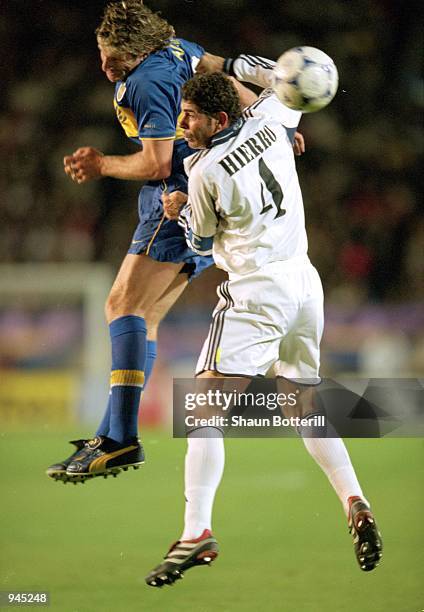 Martin Palermo of Boca Juniors and Fernando Hierro of Real Madrid clash during the Toyota Intercontinental Cup against Boca Juniors in the National...