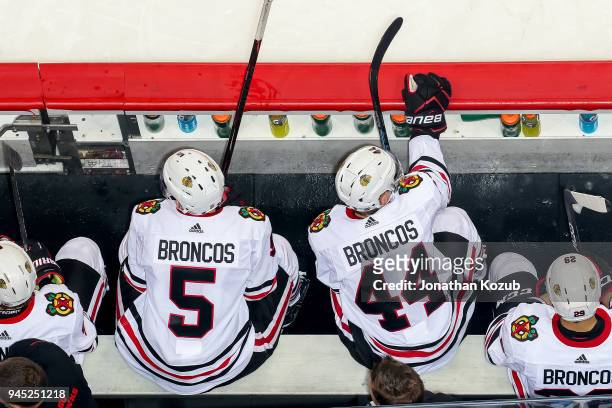 Connor Murphy and Jan Rutta of the Chicago Blackhawks look on from the bench during second period action against the Winnipeg Jets at the Bell MTS...