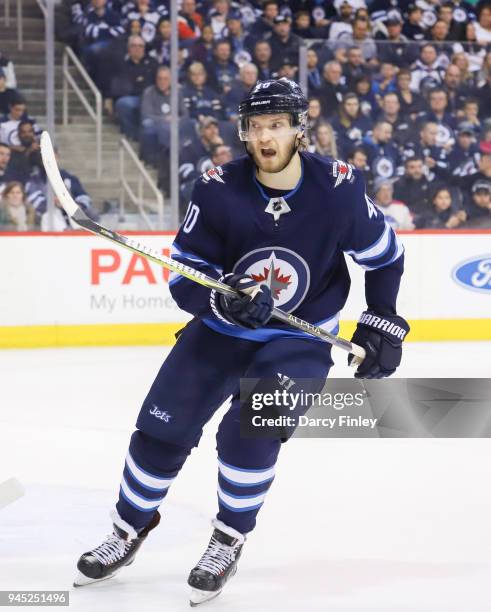 Joel Armia of the Winnipeg Jets keeps an eye on the play during third period action against the Chicago Blackhawks at the Bell MTS Place on April 7,...