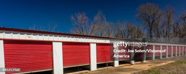 Self storage warehouse with open red doors outside Marshall, Texas Americana.