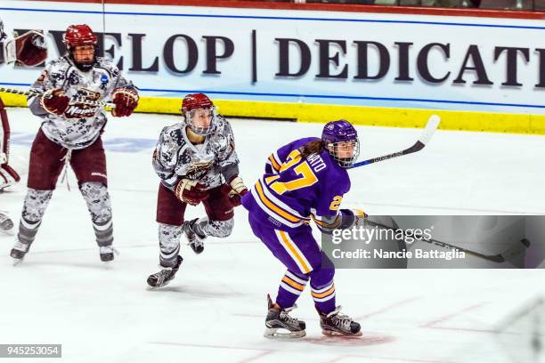 Katie Granato, of Elmira College and Nicole Goebel, of Norwich University skate up the ice after the puck during the Division III Women's Ice Hockey...