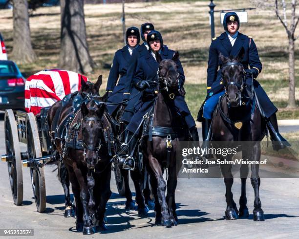 Burial at Arlington National Cemetery, Virginia, with coffin carried on horse drawn caisson.