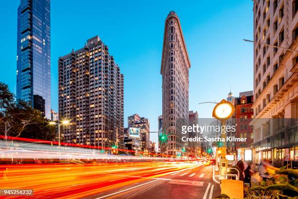 flatiron building at dusk with light trails - majestic hotel stock pictures, royalty-free photos & images