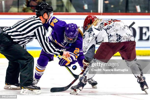 Sarah Hughson, of Elmira College and Adrieana Rossini, of Norwich University, face off during the Division III Women's Ice Hockey Championship,...