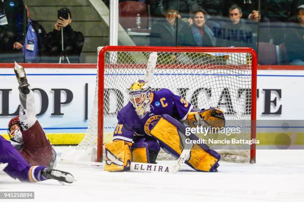 Elmira goalie, Kelcey Crawford, watches with intensity as players crash by her during the Division III Women's Ice Hockey Championship, between...