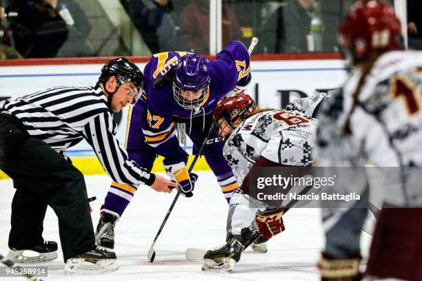 Katie Granato, of Elmira College and Brynn Wopperer face off during the Division III Women's Ice Hockey Championship, between Norwich University and...