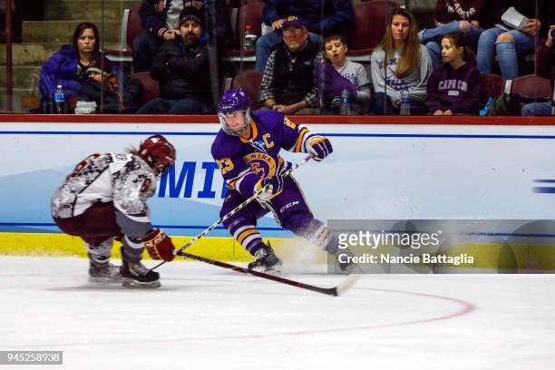 Meg Lahey, of Elmira College puts the brakes on Brynn Wopperer, of Norwich University, during the Division III Women's Ice Hockey Championship,...