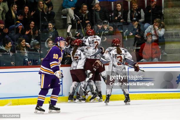 Players from Norwich University celebrate after scoring their second goal during the Division III Women's Ice Hockey Championship, between Norwich...