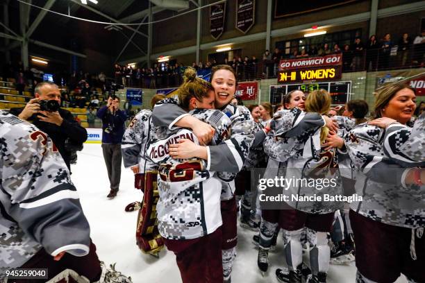 Norwich University women hug in celebration of winning the Division III Women's Ice Hockey Championship held at Kreitzberg Arena on March 17, 2018 in...