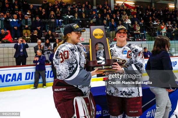 Laurie King, left, and Brynn Labbe, of Norwich University hold their championship trophy after defeating Elmira College 2-1 in the Division III...