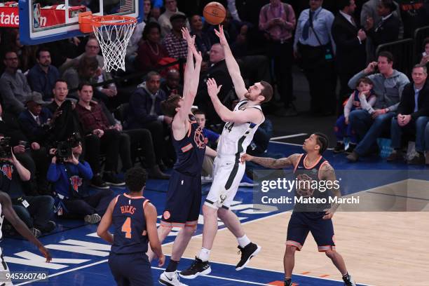 Tyler Zeller of the Milwaukee Bucks shoots the ball against Luke Kornet of the New York Knicks at Madison Square Garden on April 7, 2018 in New York...