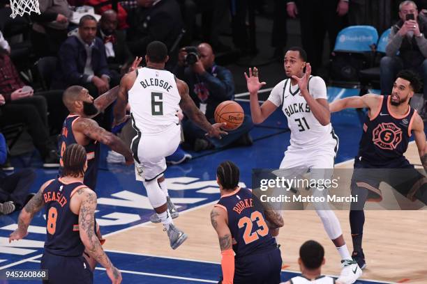 Eric Bledsoe of the Milwaukee Bucks passes the ball to teammate John Henson the game at Madison Square Garden on April 7, 2018 in New York City. NOTE...