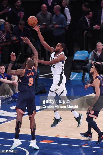 Khris Middleton of the Milwaukee Bucks lays up a shot against Kyle O'Quinn of the New York Knicks at Madison Square Garden on April 7, 2018 in New...