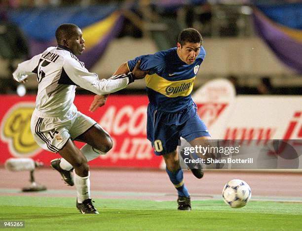 Juan Riquelme of Boca Juniors is tackled by Geremi of Real Madrid during the Toyota Intercontinental Cup against Real Madrid in the National...