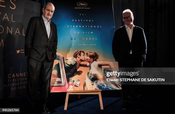President of the Cannes Film Festival Pierre Lescure and French Director Thierry Fremaux pose next to the official poster of the 71st Cannes Film...