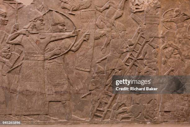 Detail from an ancient Assyrian stone carving depicting an attack on an enemy town by a river, in the British Museum, on 11th April 2018, in London,...