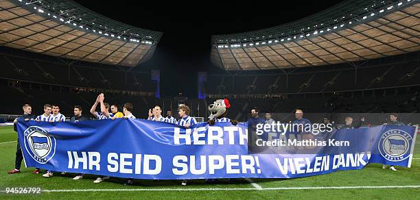 Players of Berlin show their fans a banner after winning the UEFA Europa League match between Hertha BSC Berlin and Sporting Lissabon at Olympic...