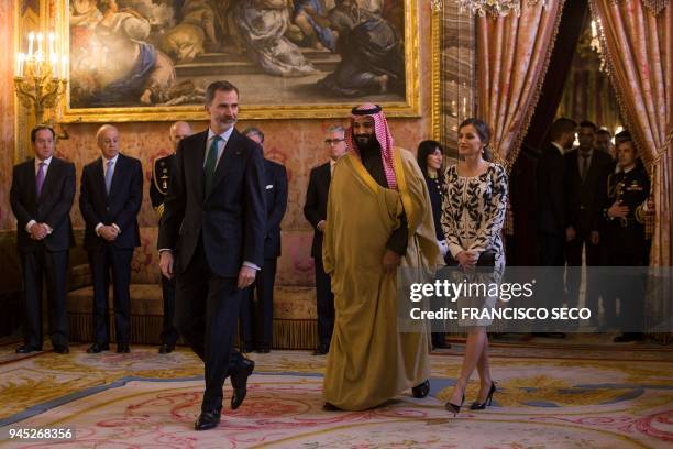 Spain's king Felipe VI walks with his wife queen Letizia and Saudi crown prince Mohammed bin Salman before a lunch at the Royal Palace in Madrid on...