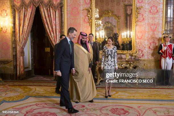 Spain's king Felipe VI walks with his wife queen Letizia and Saudi crown prince Mohammed bin Salman before a lunch at the Royal Palace in Madrid on...