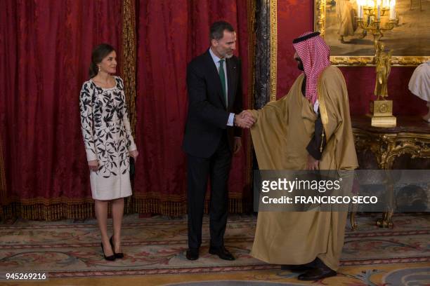 Spain's king Felipe VI shakes hands with Saudi crown prince Mohammed bin Salman beside queen Letizia before a lunch at the Royal Palace in Madrid on...