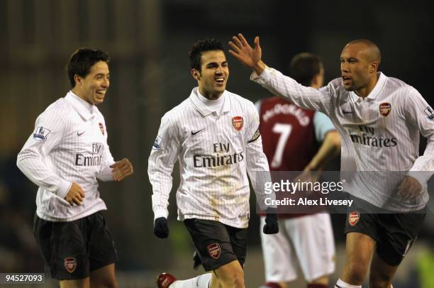 Cesc Fabregas of Arsenal celebrates with Samir Nasri and Mikael Silvestre after scoring the opening goal during the Barclays Premier League match...