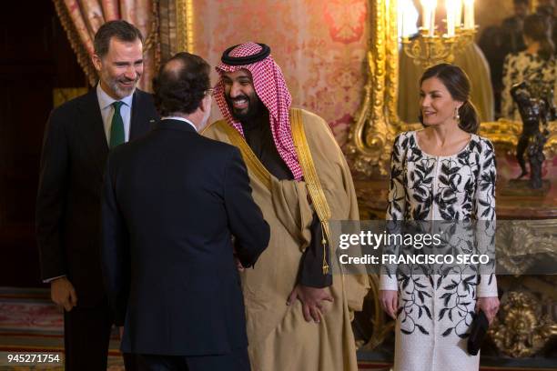 Saudi crown prince Mohammed bin Salman shakes hands with Spanish prime minister Mariano Rajoy under the eyes of Spain's king and queen Felipe VI and...