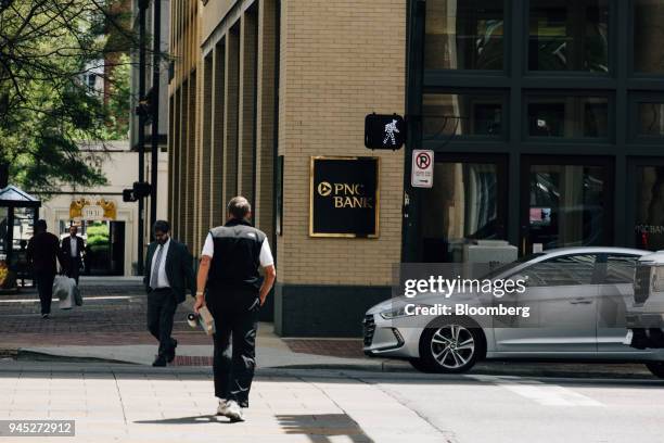 Pedestrians pass in front of a PNC Financial Services Group Inc. Bank branch in Birmingham, Alabama, U.S., on Wednesday, April 11, 2018. PNC...