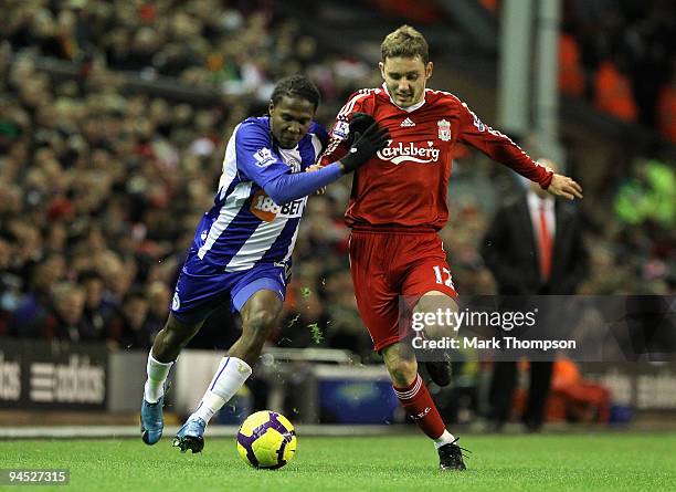 Hugo Rodallega of Wigan Athletic tussles for posession with Fabio Aurelio of Liverpool during the Barclays Premier League match between Liverpool and...