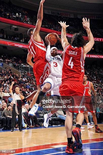 Allen Iverson of the Philadelphia 76ers goes up for a shot against Luis Scola and Shane Battier of the Houston Rockets during the game at Wachovia...