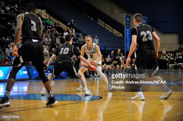 Ben Boots of Univ. Wisconsin-Oshkosh dribbles at the top of the key during the Division III Men's Basketball Championship held at the Salem Civic...