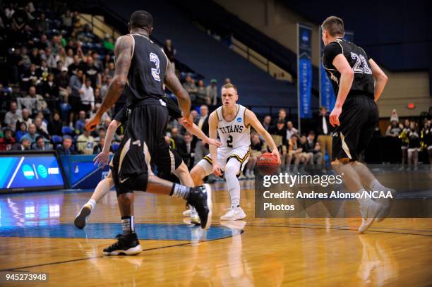 Ben Boots of Univ. Wisconsin-Oshkosh dribbles at the top of the key during the Division III Men's Basketball Championship held at the Salem Civic...