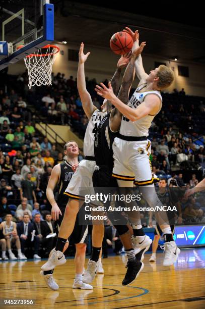 Players fight for a rebound during the Division III Men's Basketball Championship held at the Salem Civic Center on March 17, 2018 in Salem,...