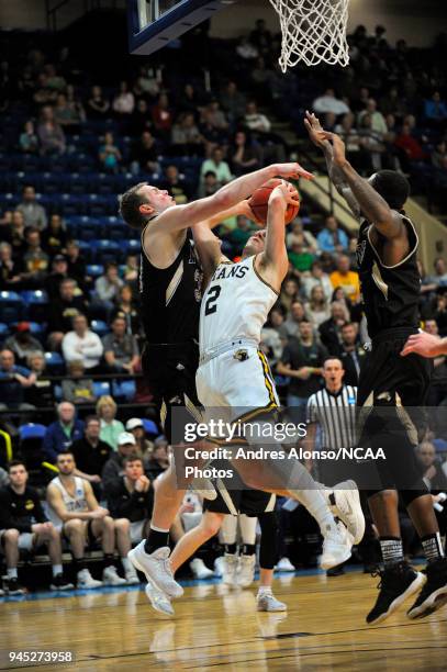Ben Boots of Univ. Wisconsin-Oshkosh gets fouled on his way up during the Division III Men's Basketball Championship held at the Salem Civic Center...