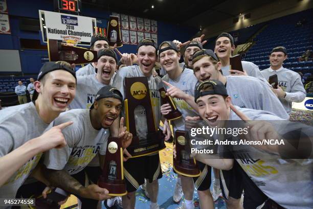 Players of Nebraska Wesleyan celebrate with their championship trophy after winning the Division III Men's Basketball Championship held at the Salem...