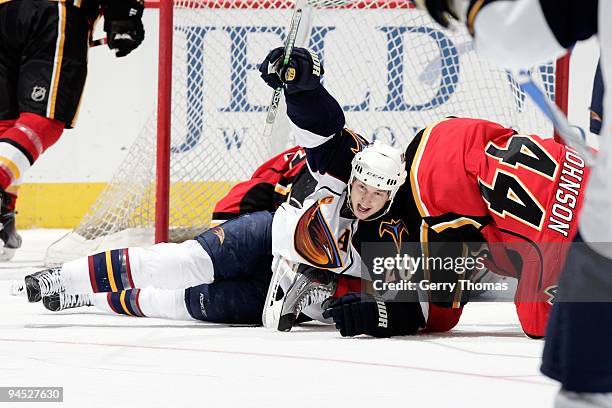 Aaron Johnson of the Calgary Flames collides with Colby Armstrong of the Atlanta Thrashers on December 9, 2009 at Pengrowth Saddledome in Calgary,...