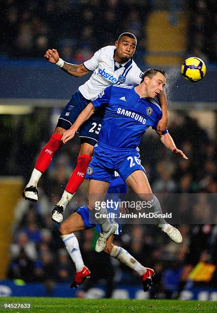 John Terry of Chelsea jumps for the ball with Kevin-Prince Boateng of Portsmouth during the Barclays Premier League match between Chelsea and...