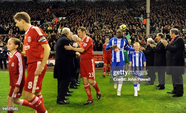 Liverpool FC players walk through the legendary Shankly team during the Barclays Premier League match between Liverpool and Wigan Athletic at Anfield...