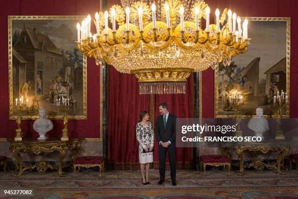 Spain's king Felipe VI and his wife queen Letizia wait for welcoming Saudi Crown prince, before a lunch at the Royal Palace in Madrid on April 12,...