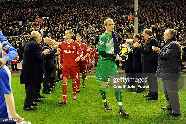 Liverpool FC players walk through the legendary Shankly team during the Barclays Premier League match between Liverpool and Wigan Athletic at Anfield...