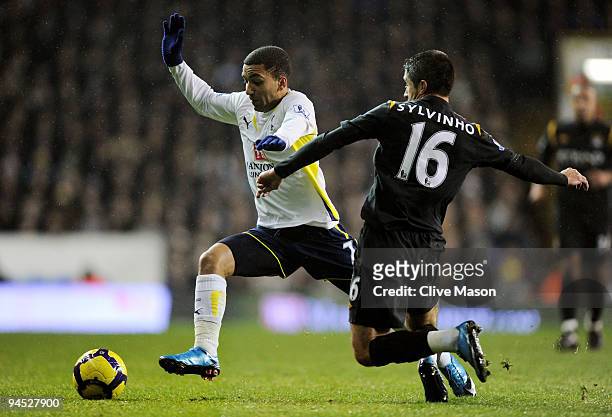 Aaron Lennon of Spurs is tackled by Sylvinho of Manchester City during the Barclays Premier League match between Tottenham Hotspur and Manchester...