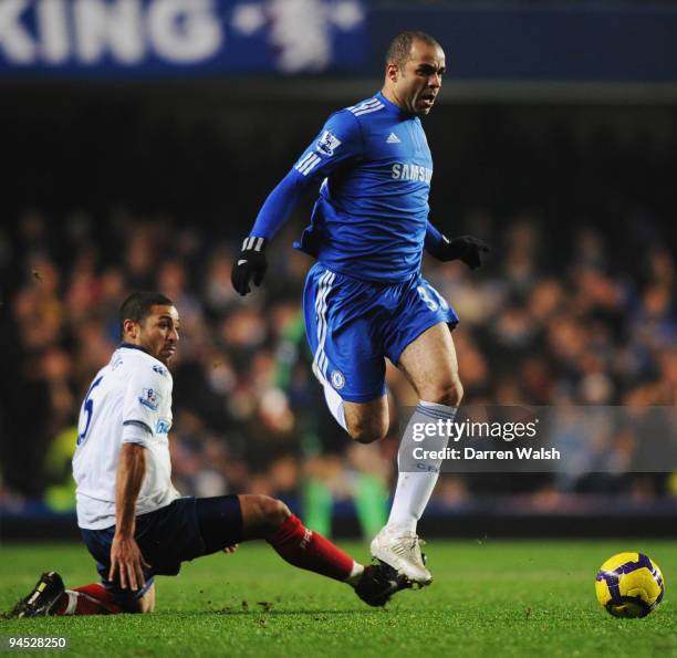 Alex of Chelsea is challenged by Hayden Mullins of Portsmouth during the Barclays Premier League match between Chelsea and Portsmouth at Stamford...