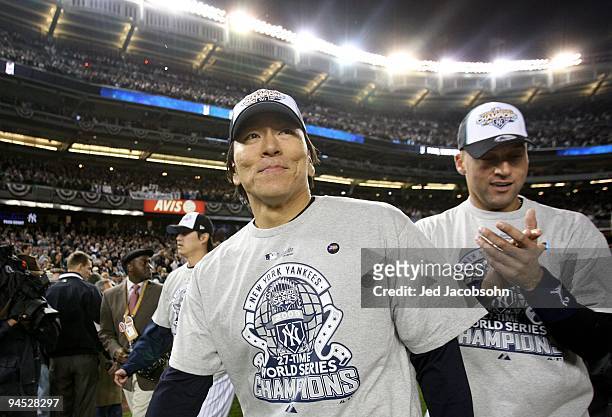 Hideki Matsui of the New York Yankees stands on the field with Derek Jeter after their 7-3 win against the Philadelphia Phillies in Game Six of the...