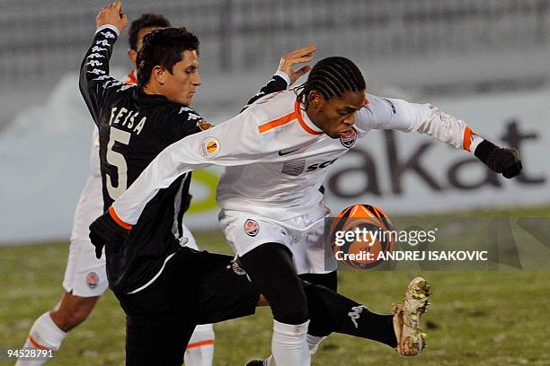 Ljubomir Fejsa of Partizan Belgrade vies with Luiz Adriano of FC Shakhtar Donetsk during their UEFA Europa League group J football match in Belgrade...