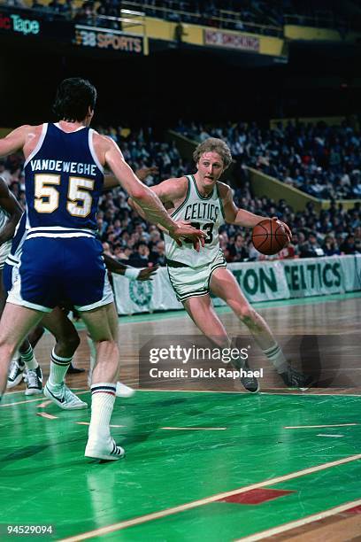 Larry Bird of the Boston Celtics drives to the basket against Kiki Vandeweghe of the Denver Nuggets during a game played in 1982 at the Boston Garden...