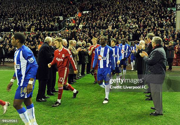 Liverpool players and Wigan players walks through the legendary Shankly team during the Barclays Premier League match between Liverpool and Wigan...