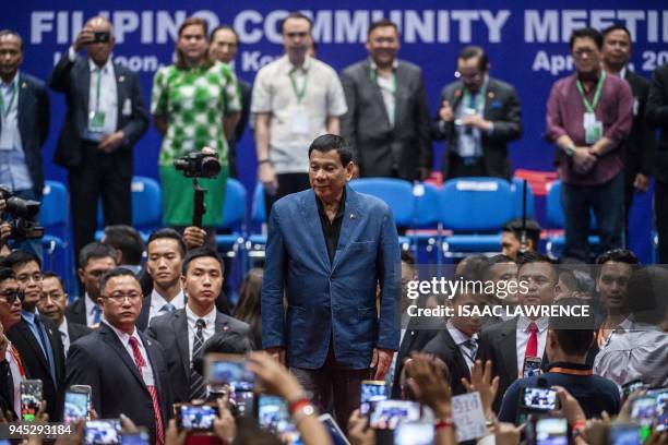 Philippines President Rodrigo Duterte poses for photos as he arrives at an event with the Filipino community during his visit to Hong Kong on April...