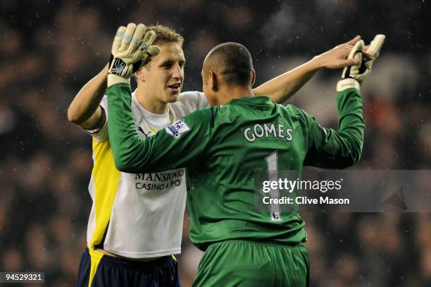 Tottenham teammates Michael Dawson and Heurelho Gomes celebrate after Jermain Defoe scores their team's second goal during the Barclays Premier...