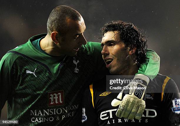 Dejected Carlos Tevez of Manchester City is consoled by Heurelho Gomes of Spurs following his team's 3-0 defeat during the Barclays Premier League...