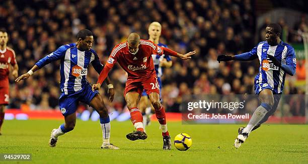 David Ngog of Liverpool battles with Charles N'zogbia of Wigan during the Barclays Premier League match between Liverpool and Wigan Athletic at...