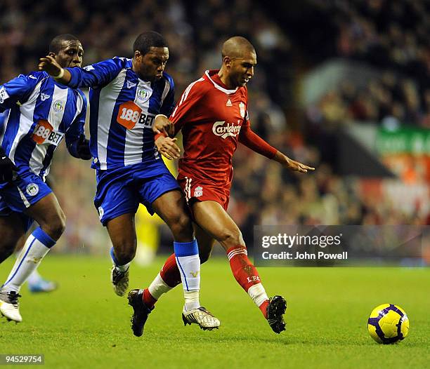 David Ngog of Liverpool battles with Charles N'zogbia of Wigan during the Barclays Premier League match between Liverpool and Wigan Athletic at...